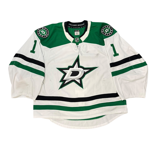 Game Worn Dallas Stars Away jersey with Stars logo on chest and number 1 on the sleeves. Jersey on a white background.