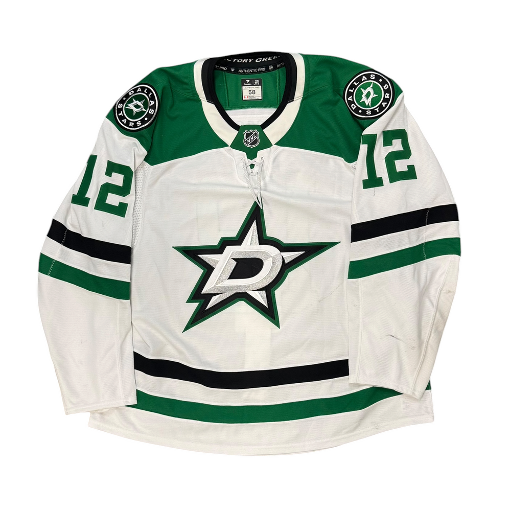 Game Worn Dallas Stars Away jersey with Stars logo on chest and number 12 on the sleeves. Jersey on a white background.