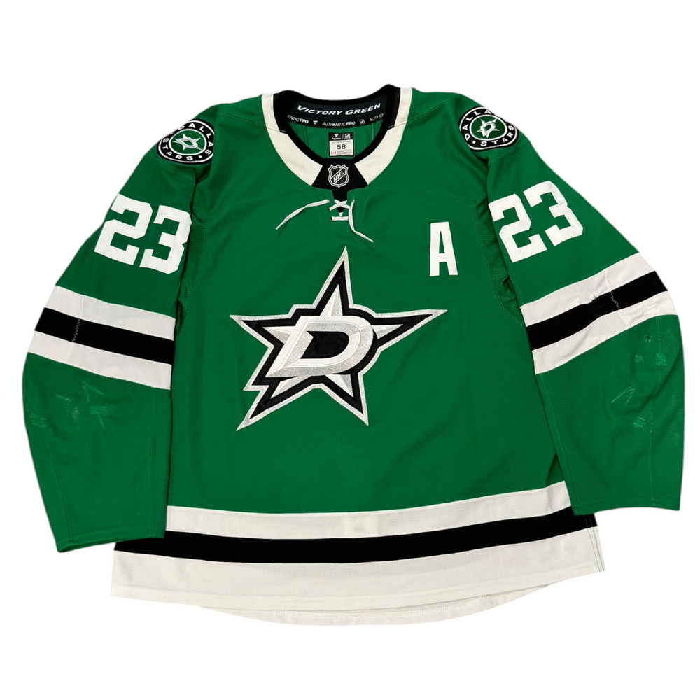 Game Worn Dallas Stars Home hockey jersey with number 23 on sleeves and Stars logo on chest with a white background