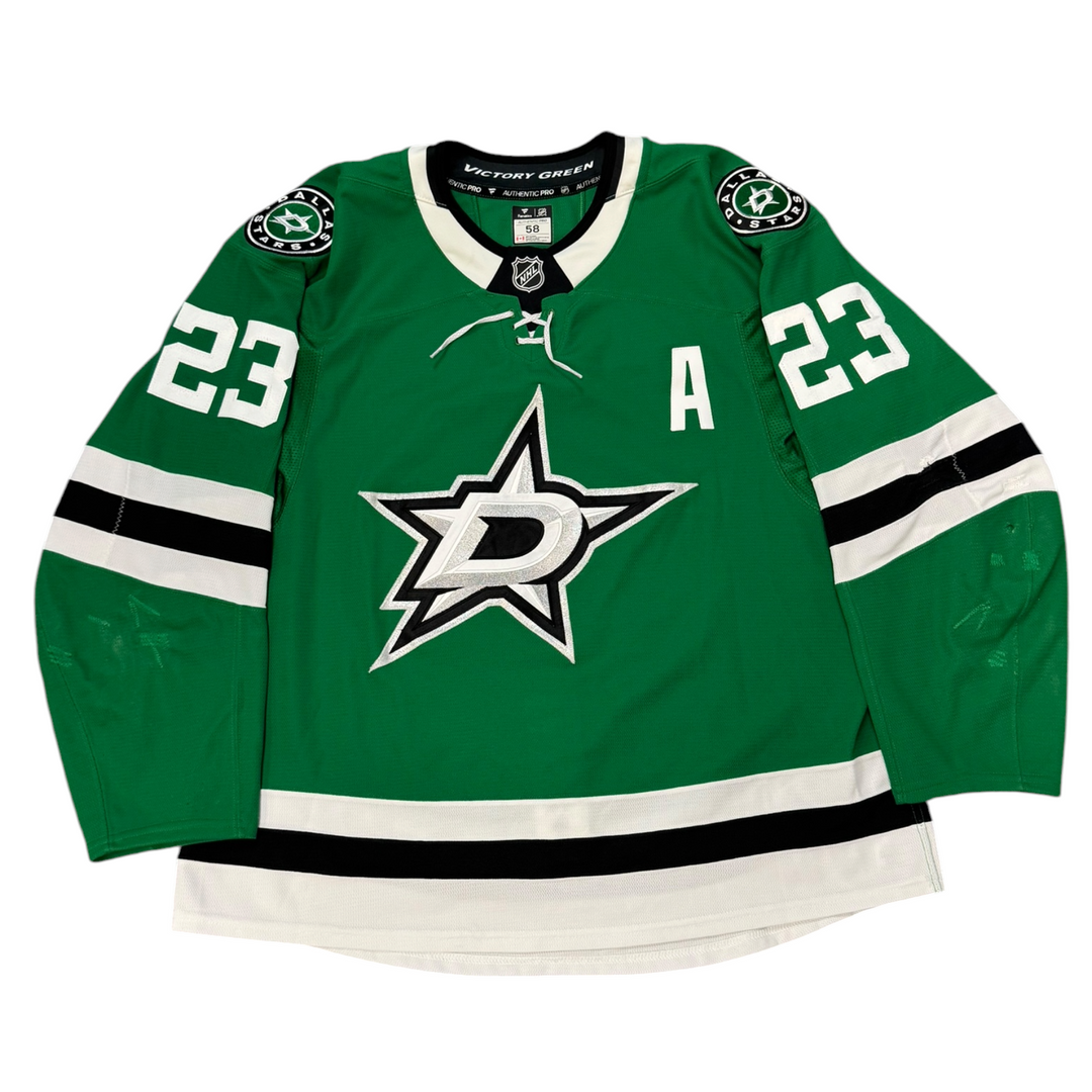 Game Worn Dallas Stars Home hockey jersey with number 23 on sleeves and Stars logo on chest with a white background