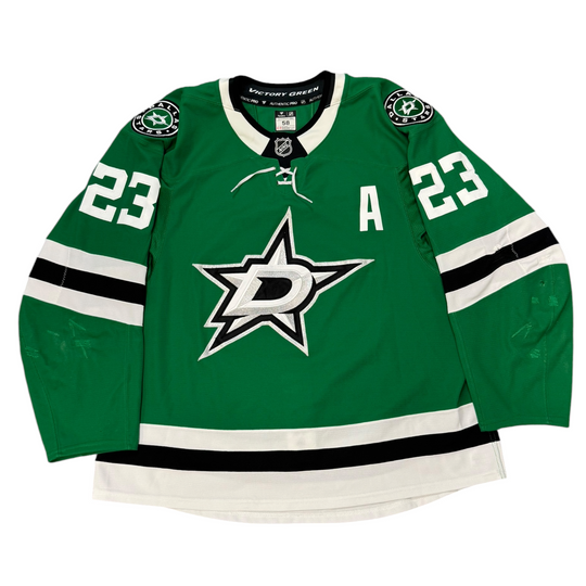 Game Worn Dallas Stars Home hockey jersey with number 23 on sleeves and Stars logo on chest with a white background