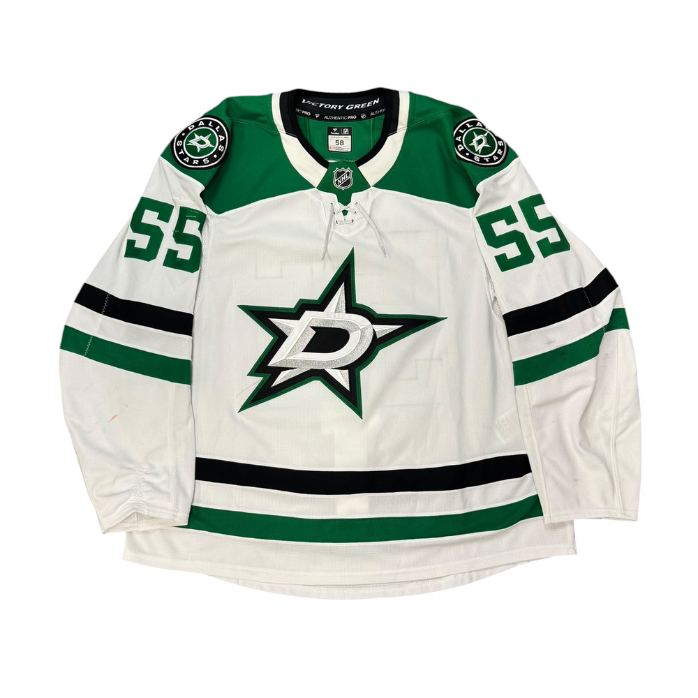 Game Worn Dallas Stars Away jersey with Stars logo on chest and number 55 on the sleeves. Jersey on a white background.
