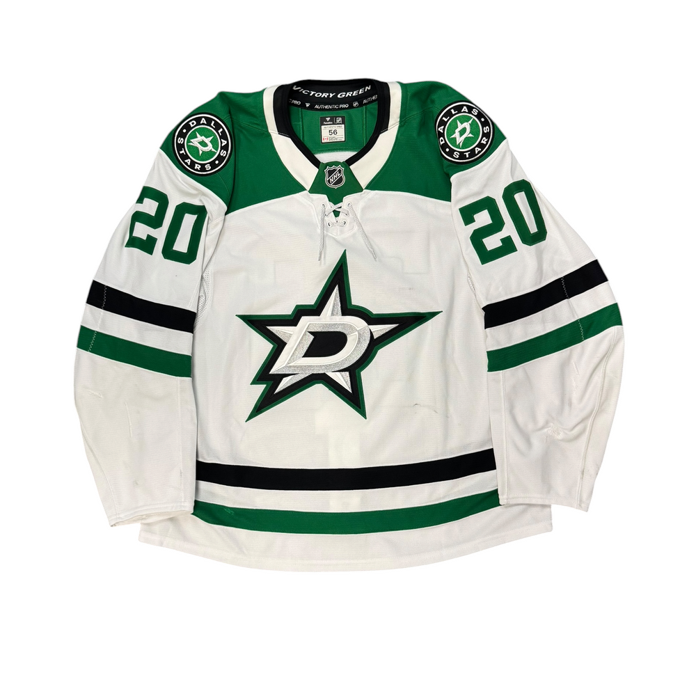 Game Worn Dallas Stars Away jersey with Stars logo on chest and number 20 on the sleeves. Jersey on a white background.