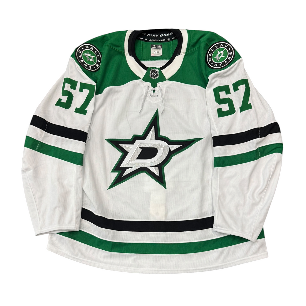 Game Worn Dallas Stars Away jersey with Stars logo on chest and number 57 on the sleeves. Jersey on a white background.