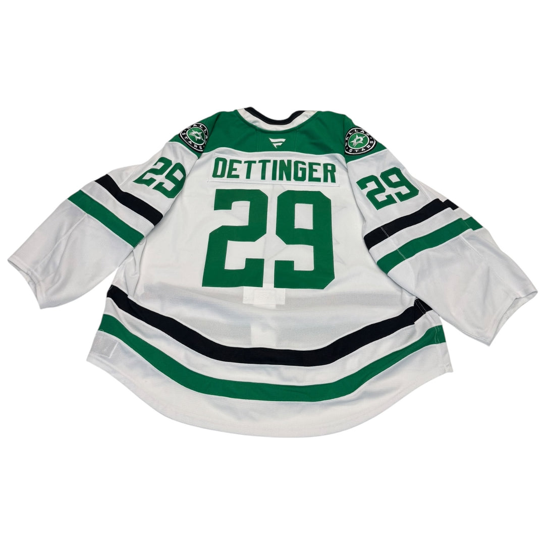Game worn Dallas Stars away jersey with number 29 and name 'Oettinger'. jersey on a white background