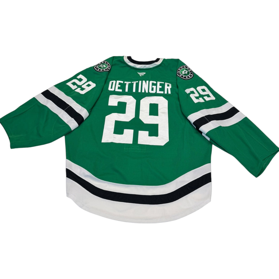 Game worn Dallas Stars home hockey jersey with number 29 and name 'Oettinger' on a white background