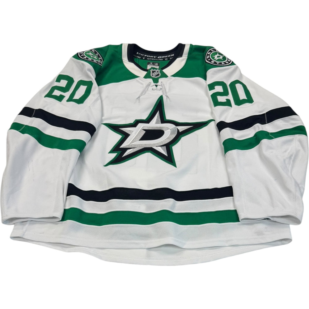 Game worn Dallas Stars Away jersey, number 20 on the sleeves with Dallas Stars logo on the chest. Hockey jersey on a white background
