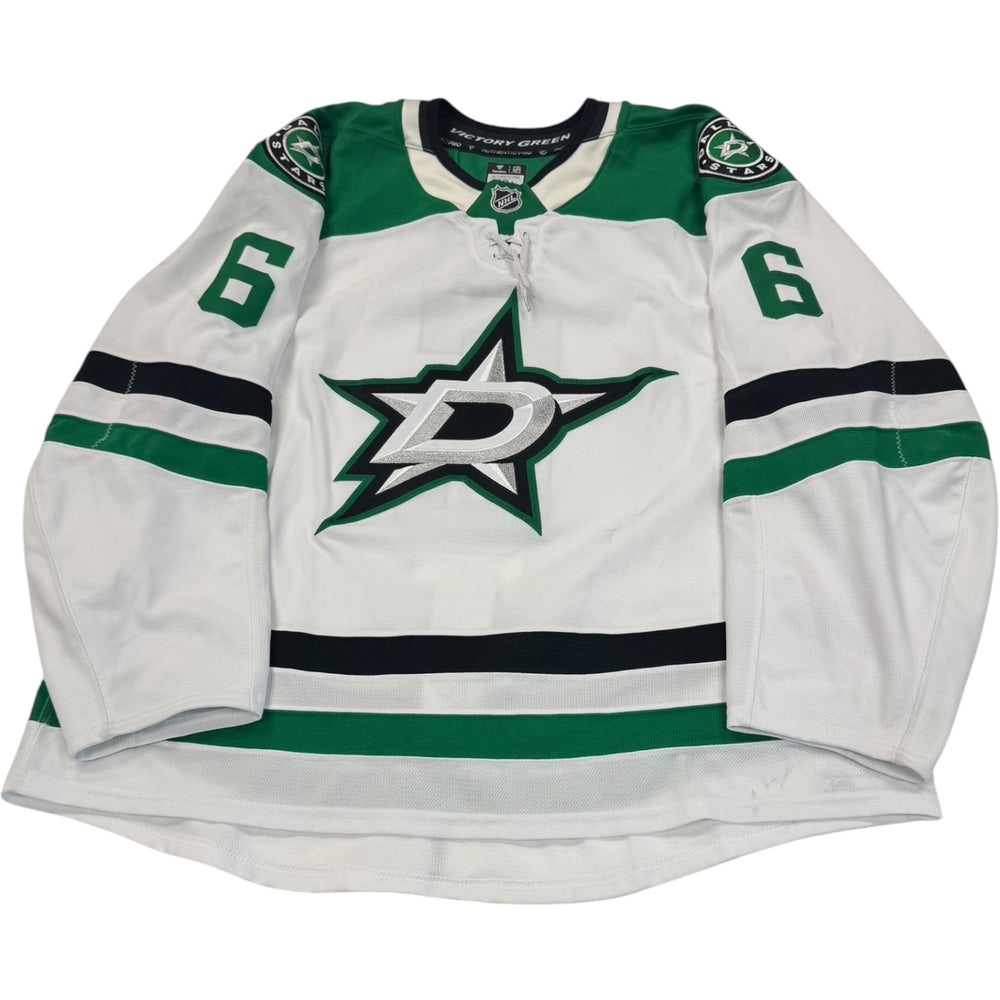 Game worn Dallas Stars Away jersey, number 6 on the sleeves with Dallas Stars logo on the chest. Hockey jersey on a white background

