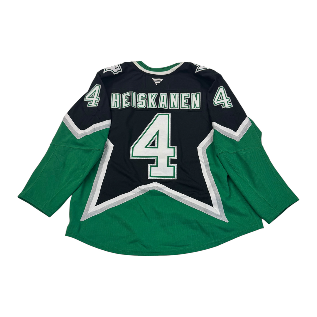 BACK OF MIRO HEISKANEN PLAYOFF GAME WORN '99 ALTERNATE JERSEY. Hockey jersey with 'Heiskanen' and number '4' jersey on a white background