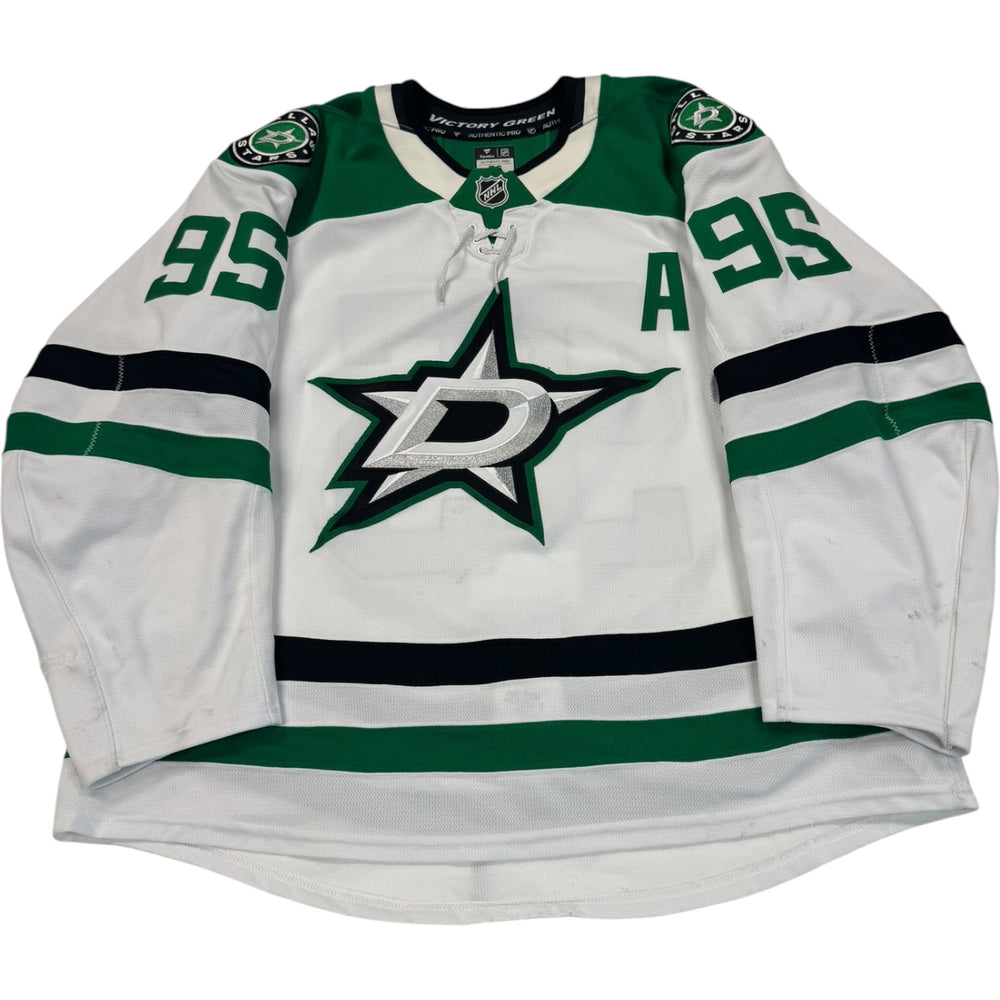 Game worn Dallas Stars Away jersey, number 95 on the sleeves with Dallas Stars logo on the chest. Hockey jersey on a white background
