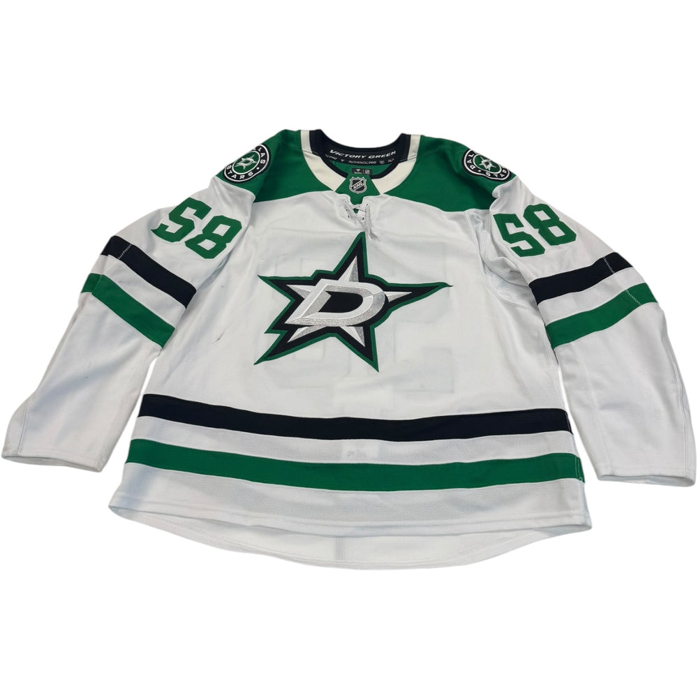 Game worn Dallas Stars Away jersey, number 58on the sleeves with Dallas Stars logo on the chest. Hockey jersey on a white background
