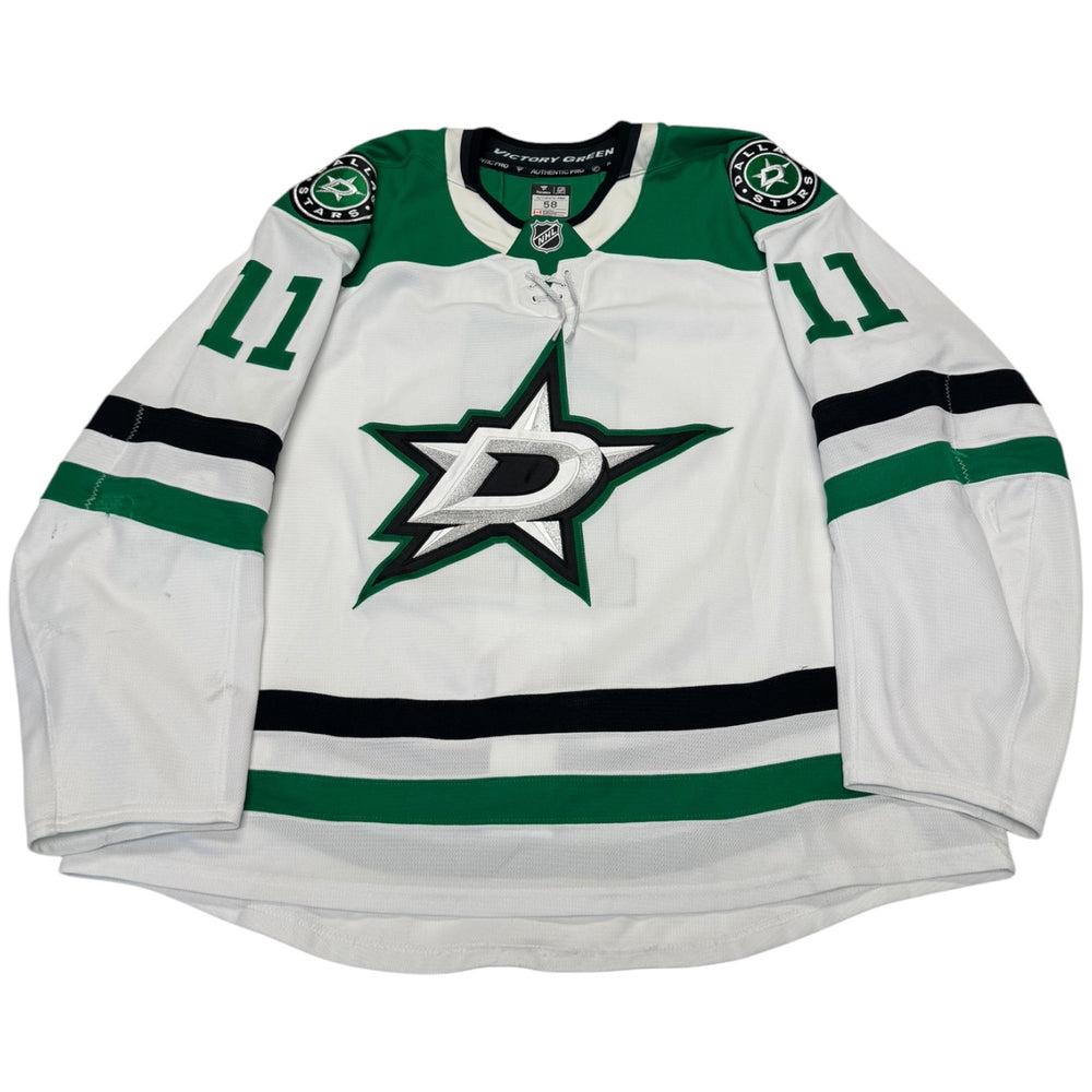 Game worn Dallas Stars Away jersey, number 11 on the sleeves with Dallas Stars logo on the chest. Hockey jersey on a white background
