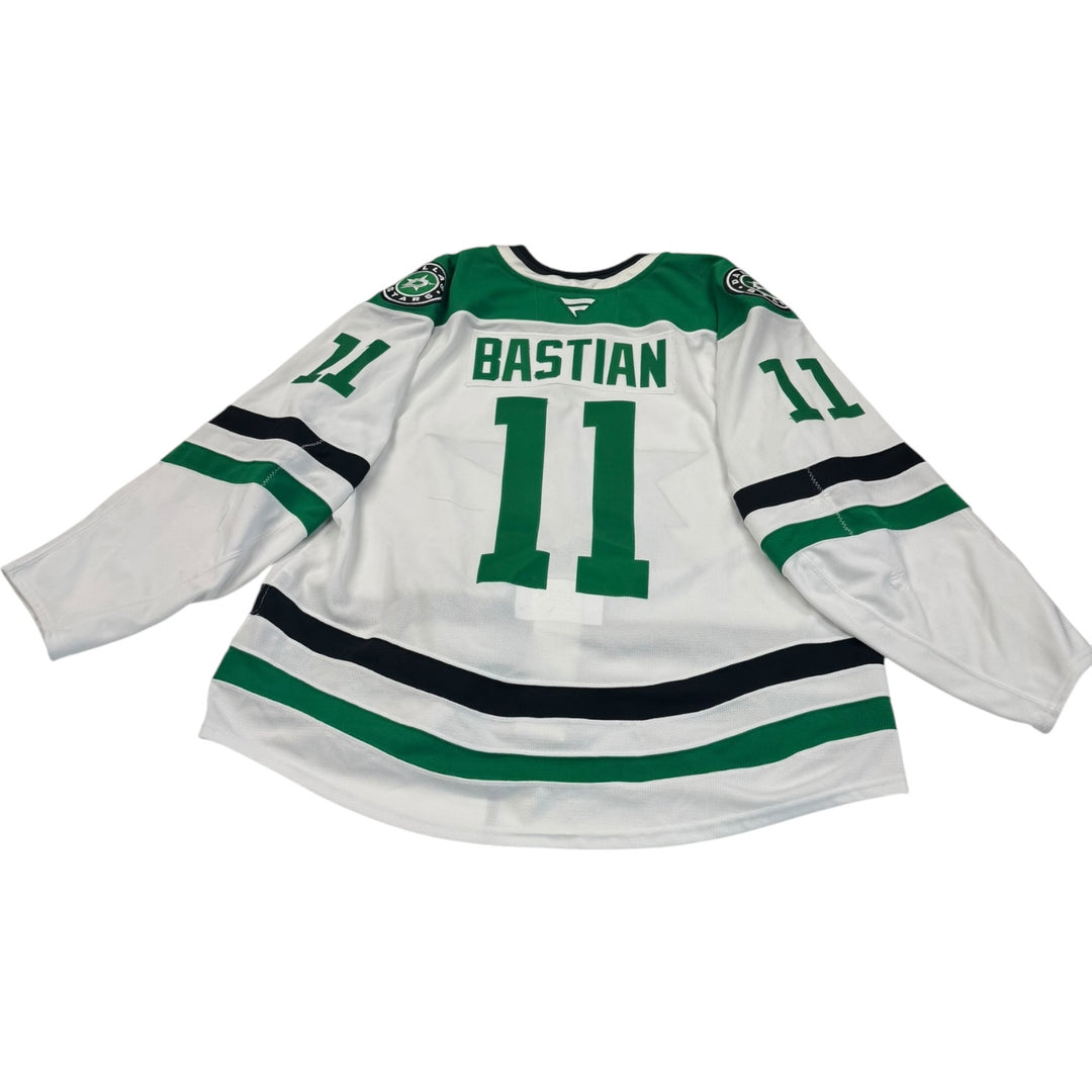 Game worn Dallas Stars away jersey with 'Bastian' and number '11'. Jersey on a white background