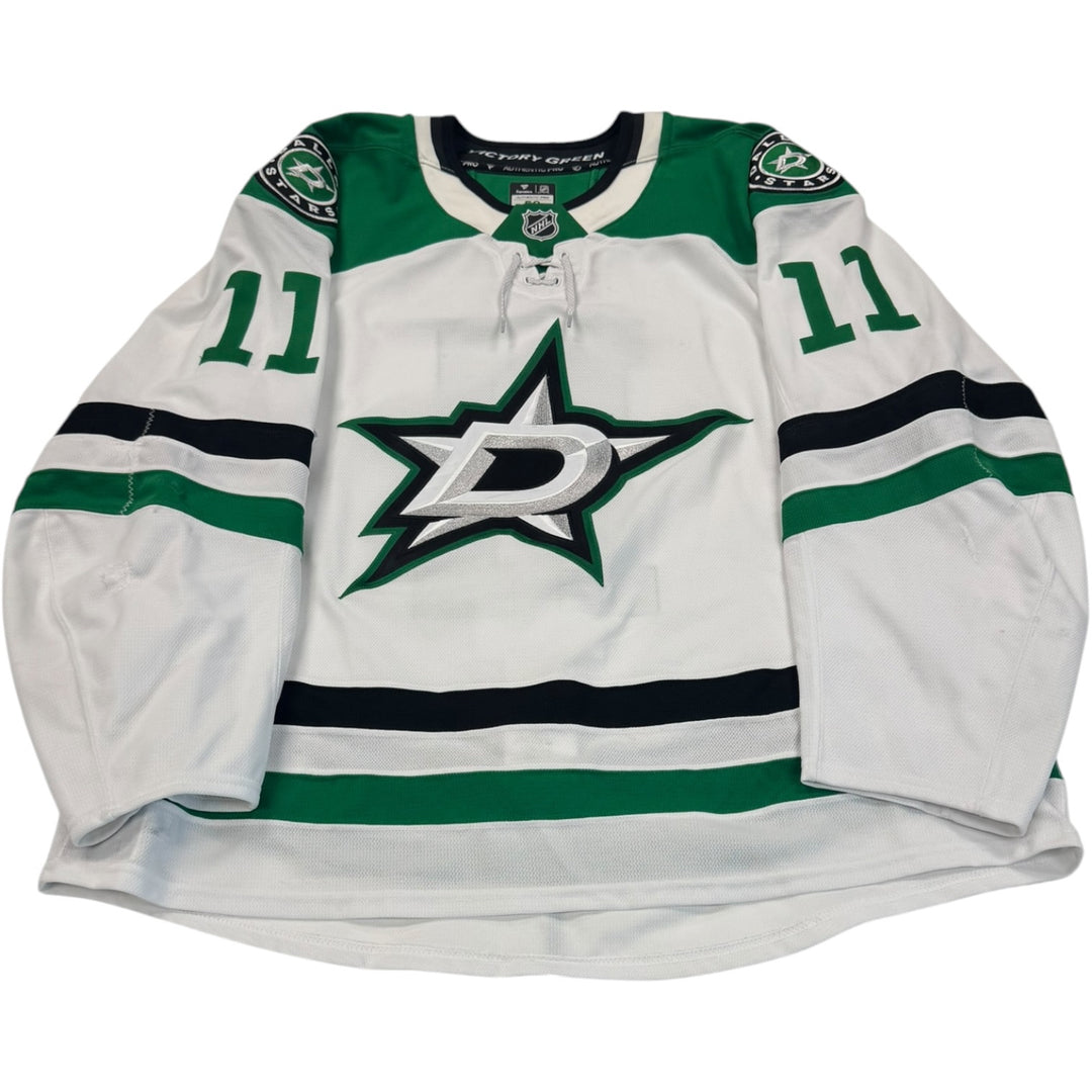 Game worn Dallas Stars Away jersey, number 11 on the sleeves with Dallas Stars logo on the chest. Hockey jersey on a white background
