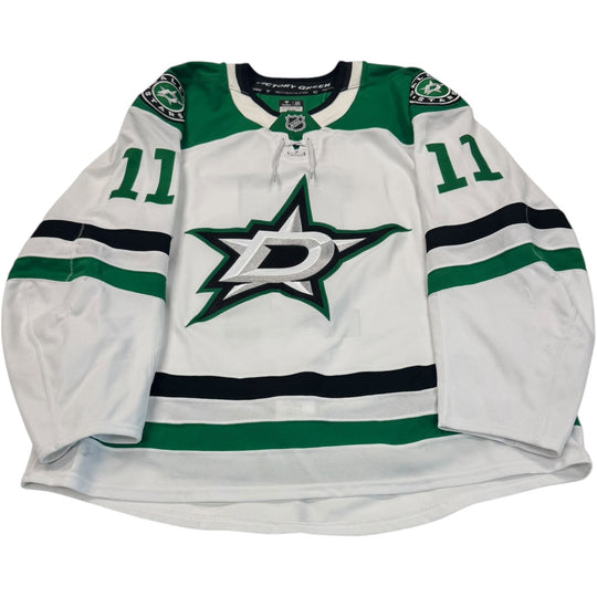 Game worn Dallas Stars Away jersey, number 11 on the sleeves with Dallas Stars logo on the chest. Hockey jersey on a white background
