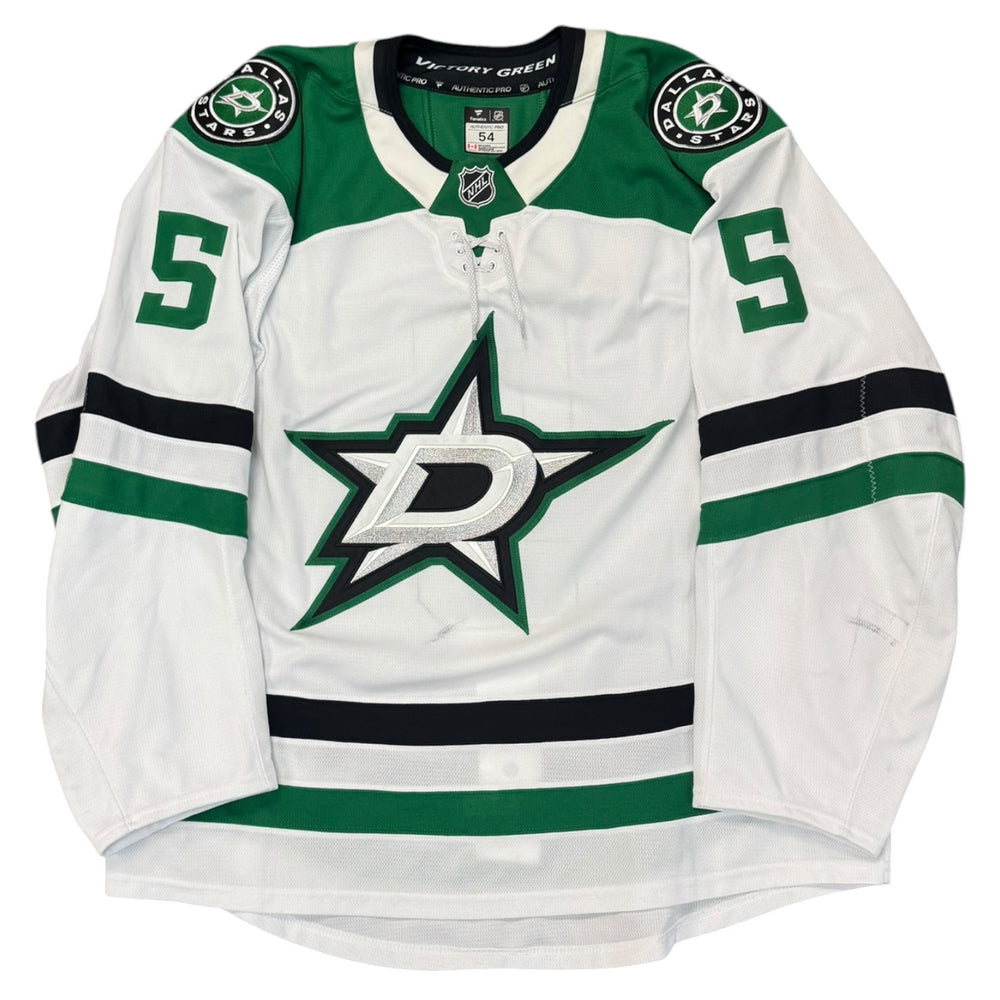 Game worn Dallas Stars Away jersey, number 5 on the sleeves with Dallas Stars logo on the chest. Hockey jersey on a white background
