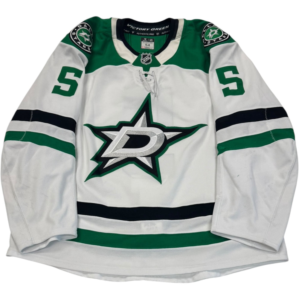 Game worn Dallas Stars Away jersey, number 5 on the sleeves with Dallas Stars logo on the chest. Hockey jersey on a white background
