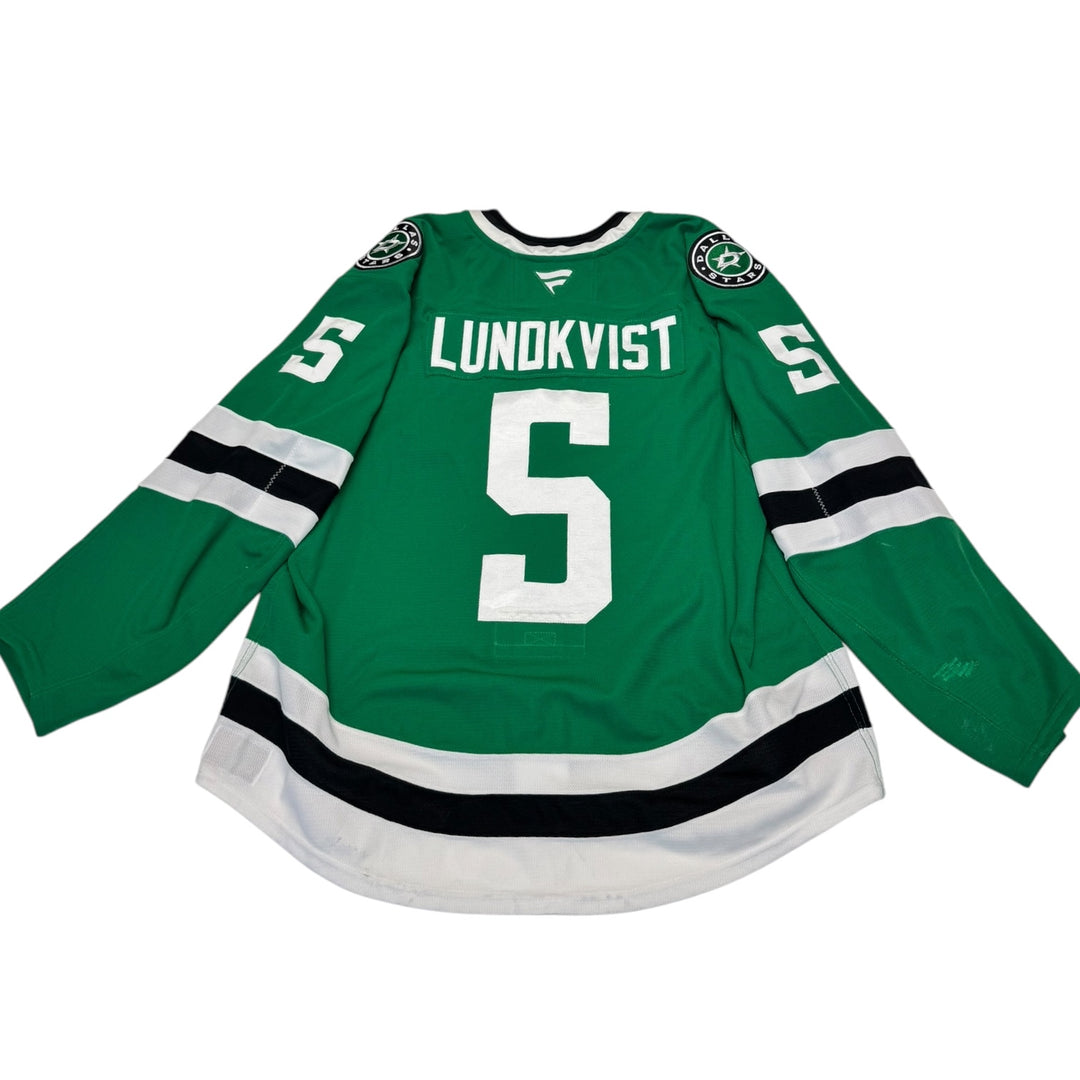 Game worn Dallas Stars home hockey jersey with 'Lundkvist' and number '5' on a white background