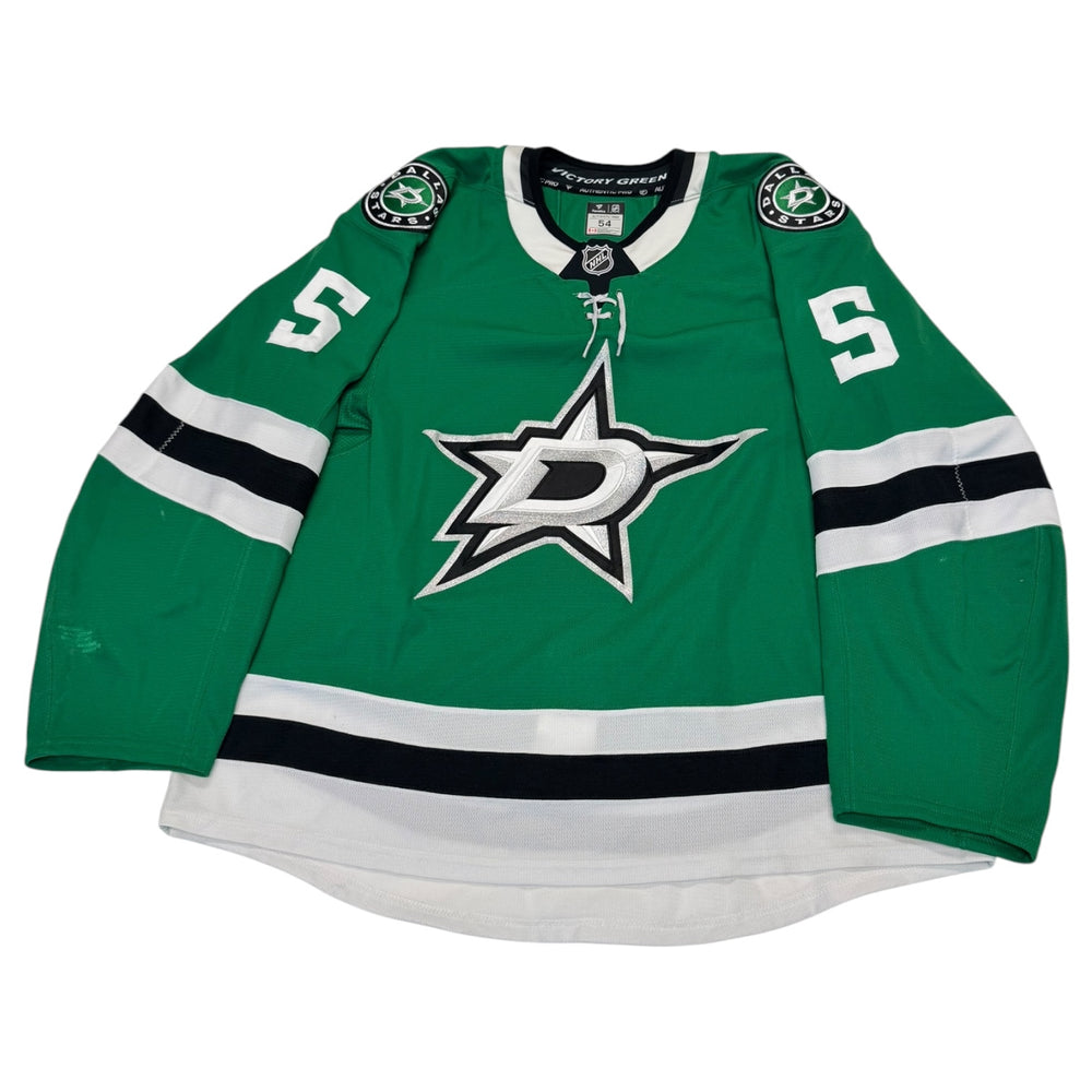 Green hockey jersey with a star logo and number 5 on a white background