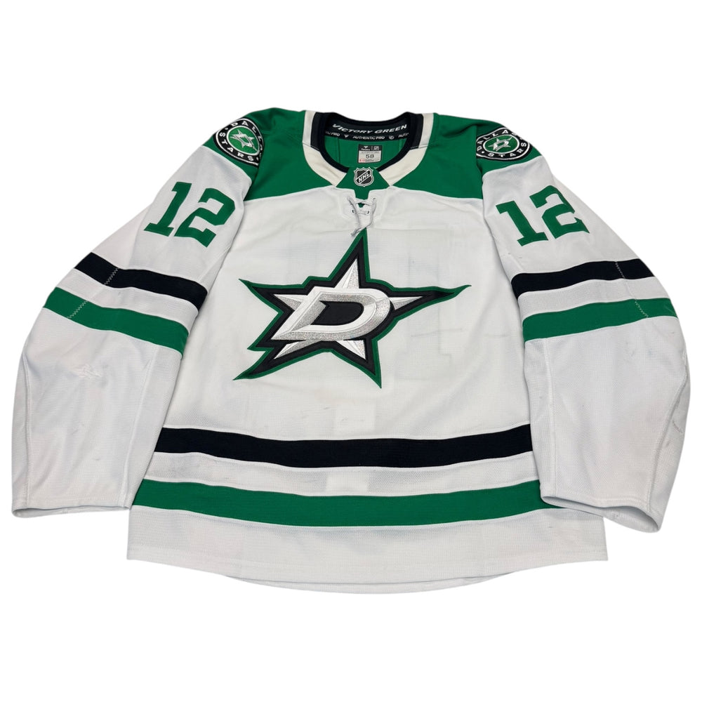 Game worn Dallas Stars Away jersey, number 12 on the sleeves with Dallas Stars logo on the chest. Hockey jersey on a white background
