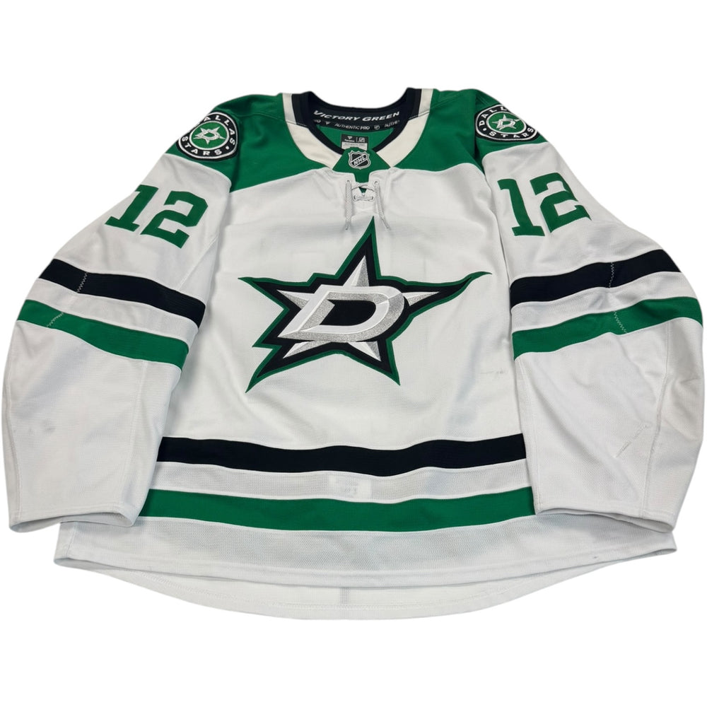 Game worn Dallas Stars Away jersey, number 12 on the sleeves with Dallas Stars logo on the chest. Hockey jersey on a white background
