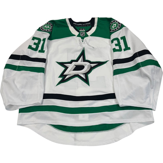 Game worn Dallas Stars Away jersey, number 31 on the sleeves with Dallas Stars logo on the chest. Hockey jersey on a white background
