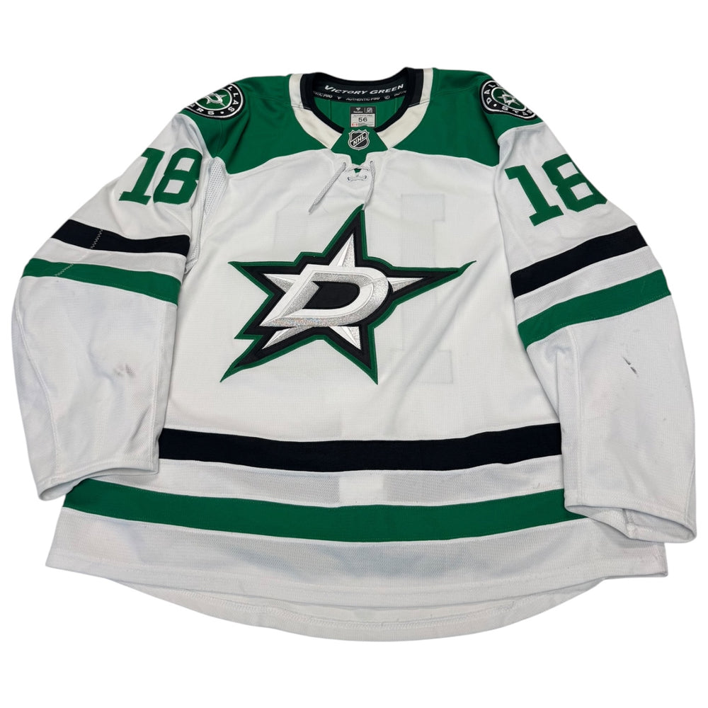 Game worn Dallas Stars Away jersey, number 18 on the sleeves with Dallas Stars logo on the chest. Hockey jersey on a white background
