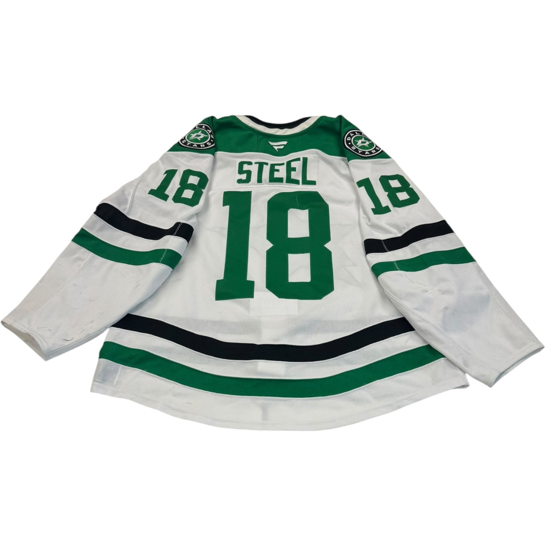 Game worn Dallas Stars away jersey with number 18 and name 'Steel'. Jersey on a white background