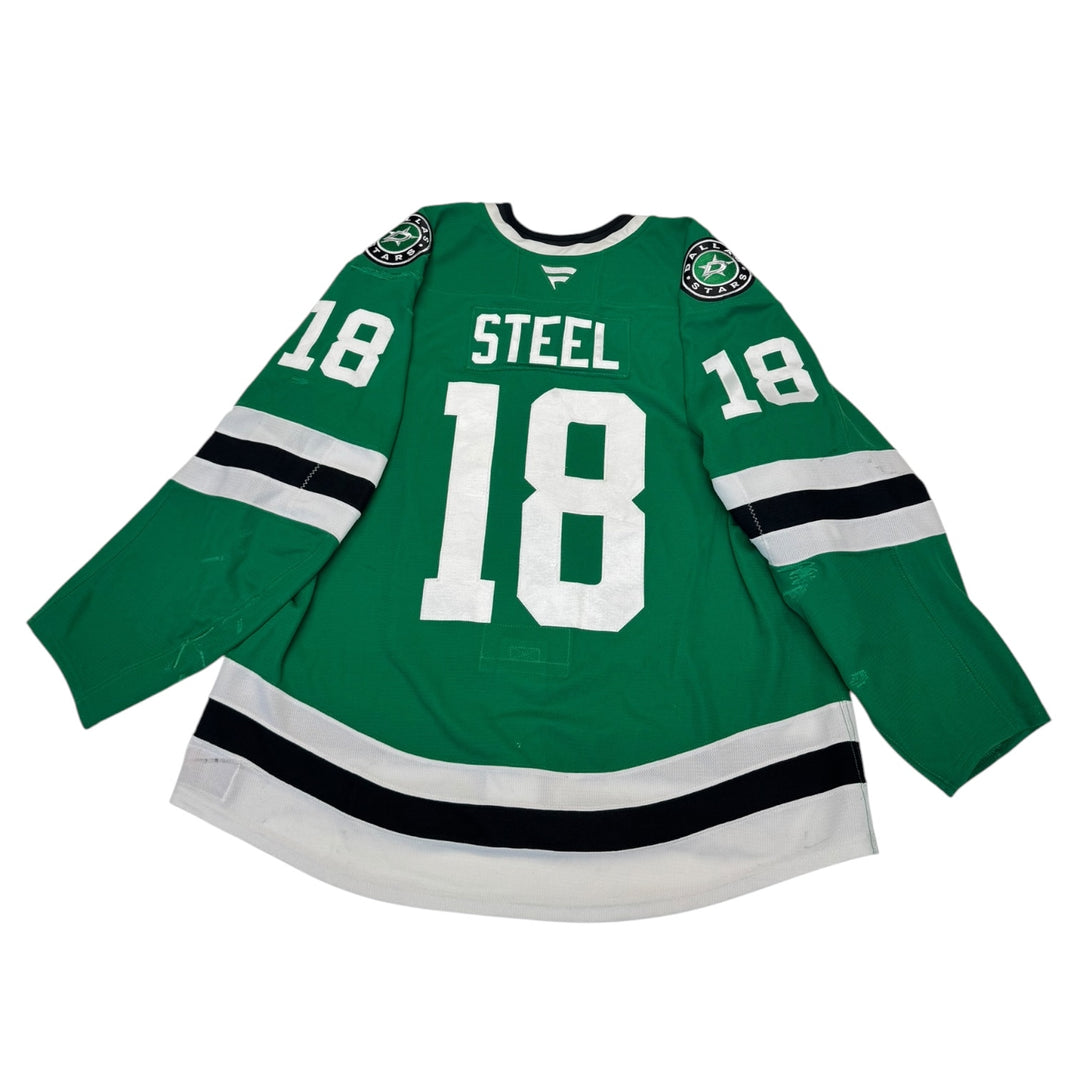 Game worn Dallas Stars homehockey jersey with number 18 and name 'Steel' on a white background