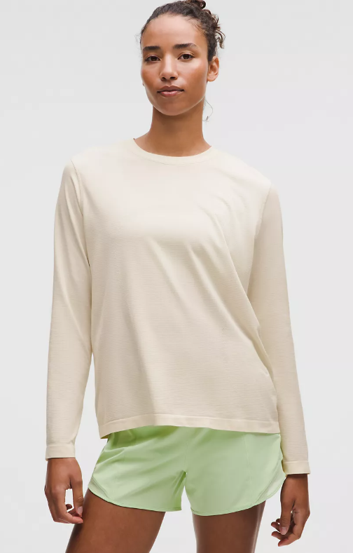 Photo of Lululemon model wearing light ivory swiftly relaxed long sleeve tee without logo front view