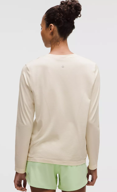 Photo of Lululemon model wearing light ivory swiftly relaxed long sleeve tee without logo back view