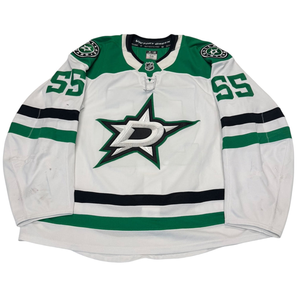 Game worn Dallas Stars Away jersey, number 55 on the sleeves with Dallas Stars logo on the chest. Hockey jersey on a white background

