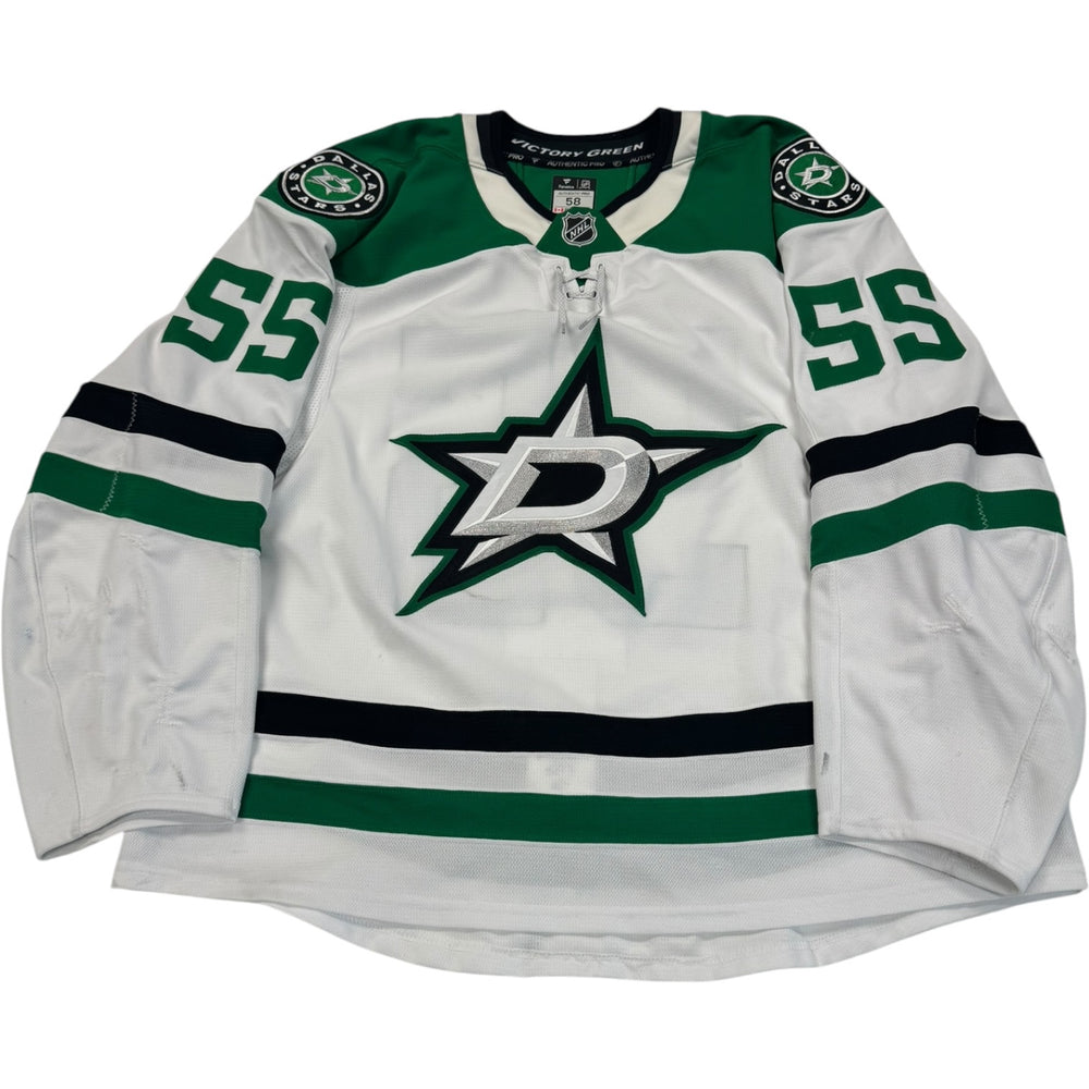 Game worn Dallas Stars Away jersey, number 55 on the sleeves with Dallas Stars logo on the chest. Hockey jersey on a white background

