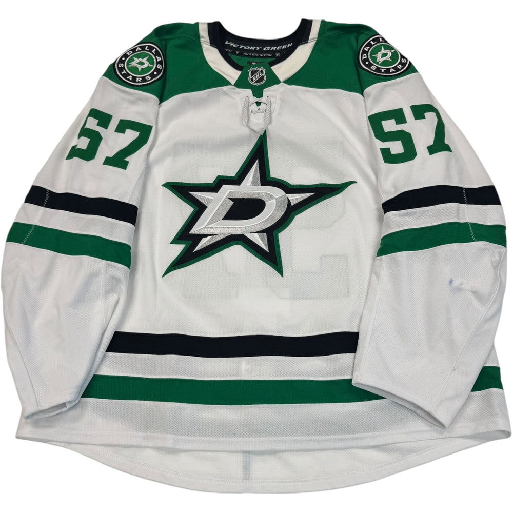 Game worn Dallas Stars Away jersey, number 57 on the sleeves with Dallas Stars logo on the chest. Hockey jersey on a white background
