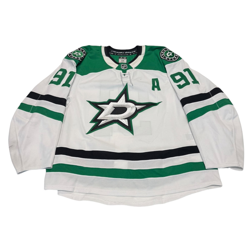 Game worn Dallas Stars Away jersey, number 91 on the sleeves with Dallas Stars logo on the chest. Hockey jersey on a white background
