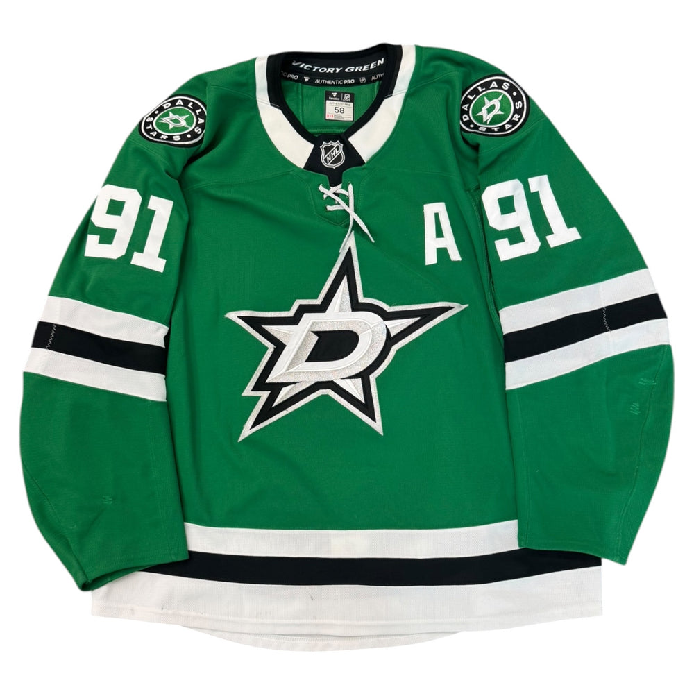 Game worn Dallas Stars Away jersey, number 91 on the sleeves with Dallas Stars logo on the chest. Hockey jersey on a white background
